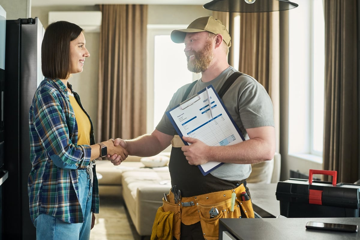 Happy customer handshake with craftsman